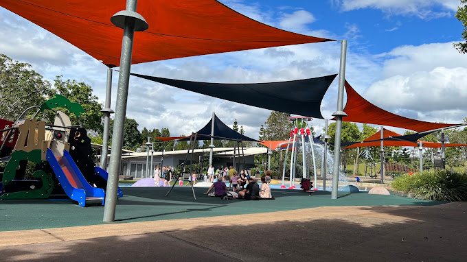 Shaded playground and splash pad at Robelle Domain