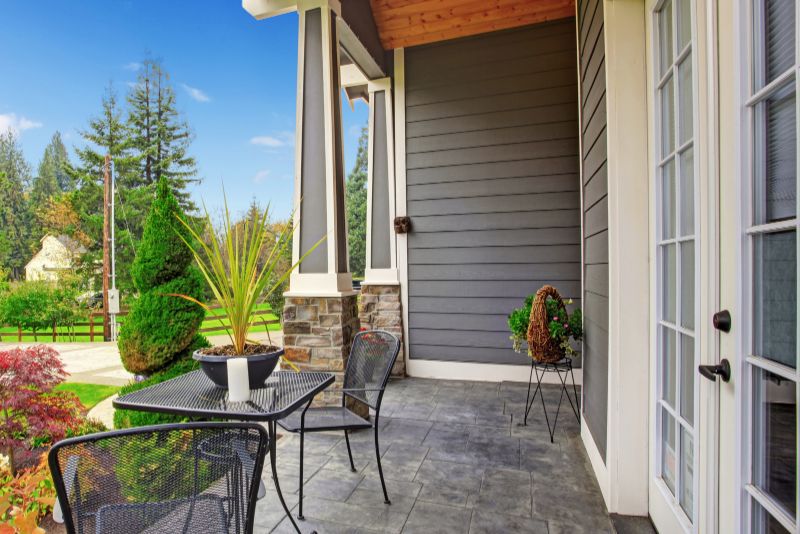 Attached verandah styled with potted plants and outdoor furniture