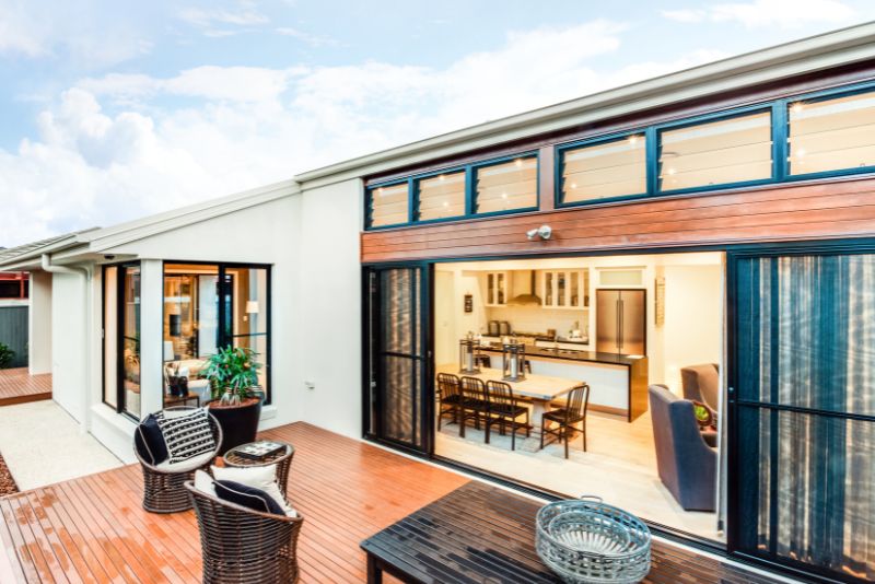 Timber deck furnished as an outdoor living space with table and chairs